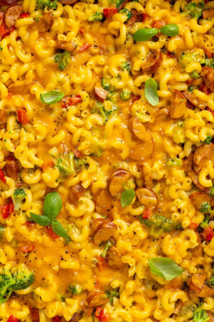 Close-up of creamy broccoli cheddar pasta showing tender pasta, broccoli and melted cheddar