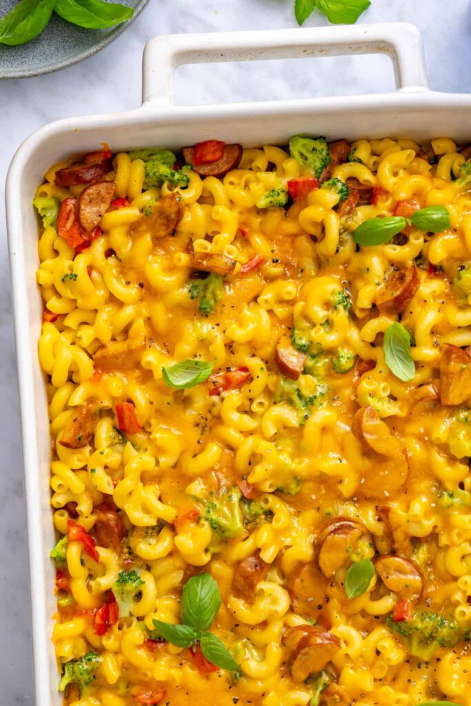 Close-up of golden cheddar topping, broccoli and chicken sausage in baked pasta