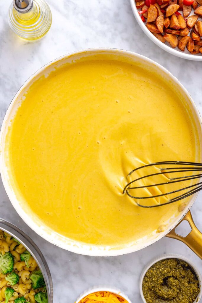 Cottage cheese cheddar sauce gently heating and thickening in a skillet