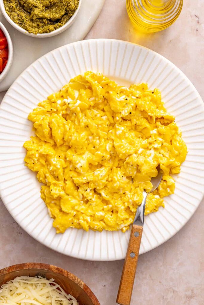Soft scrambled eggs ready to add to chicken pesto breakfast burritos