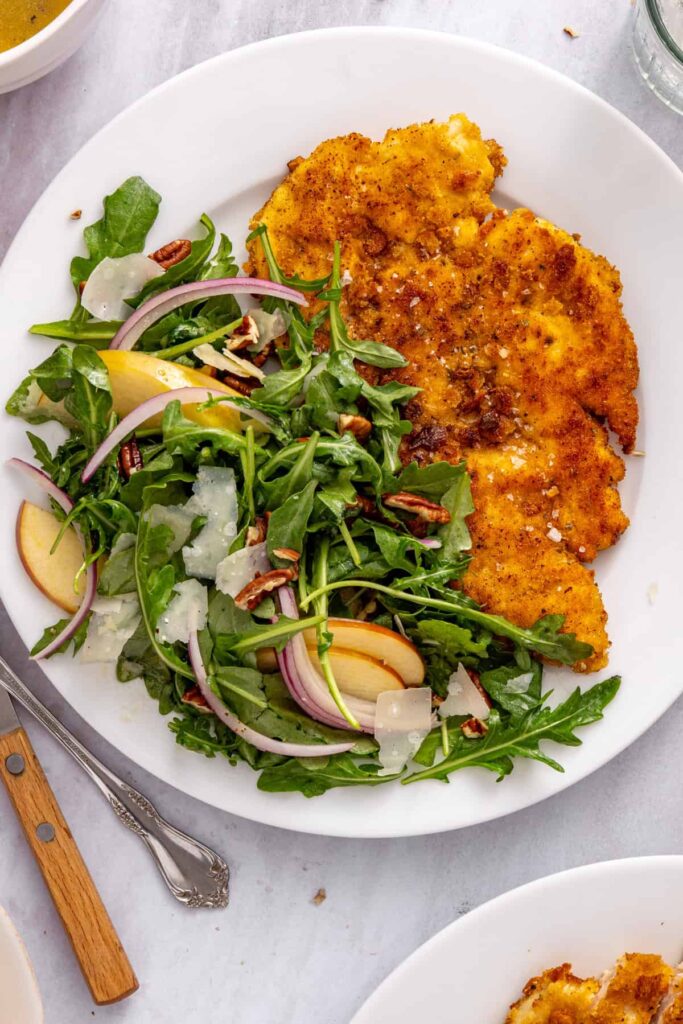 Overhead close-up highlighting the crunchy breadcrumb crust and tender sliced chicken in a crispy chicken cutlet dinner.