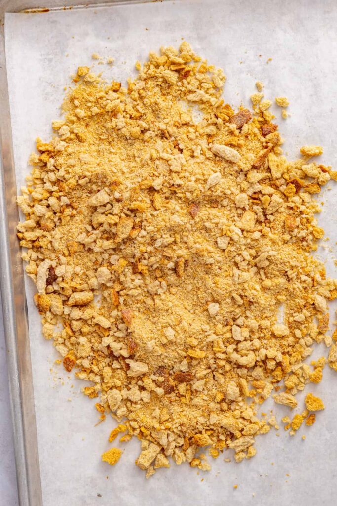Coarse toasted sourdough breadcrumbs prepared for coating homemade crispy chicken cutlets.