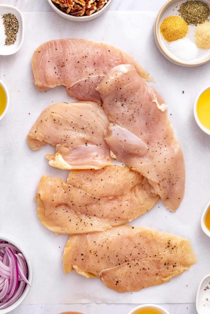 Chicken breast cutlets evenly seasoned with salt and pepper for crispy pan-fried chicken.