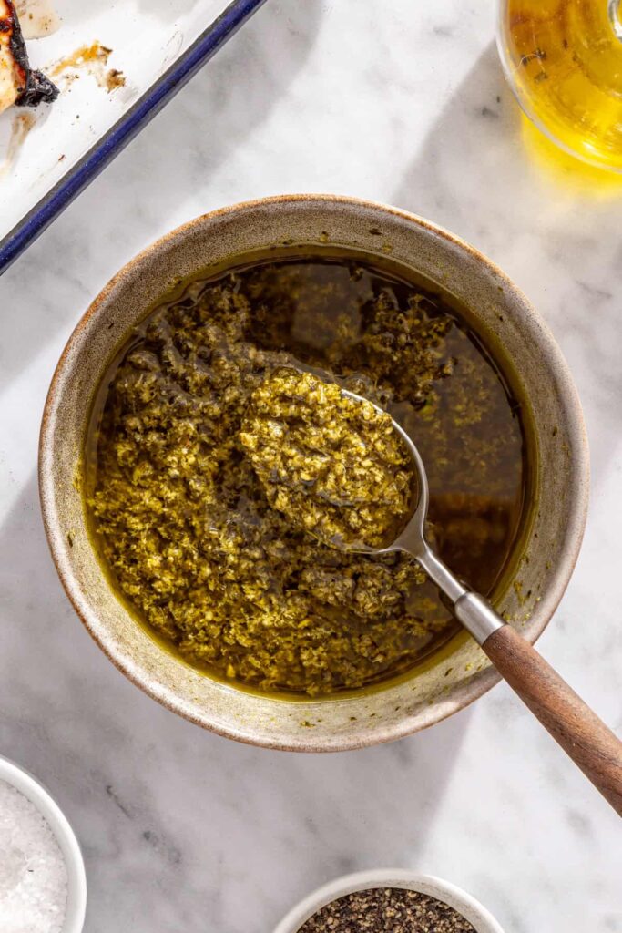 Homemade-style pesto dressing made with olive oil and prepared pesto