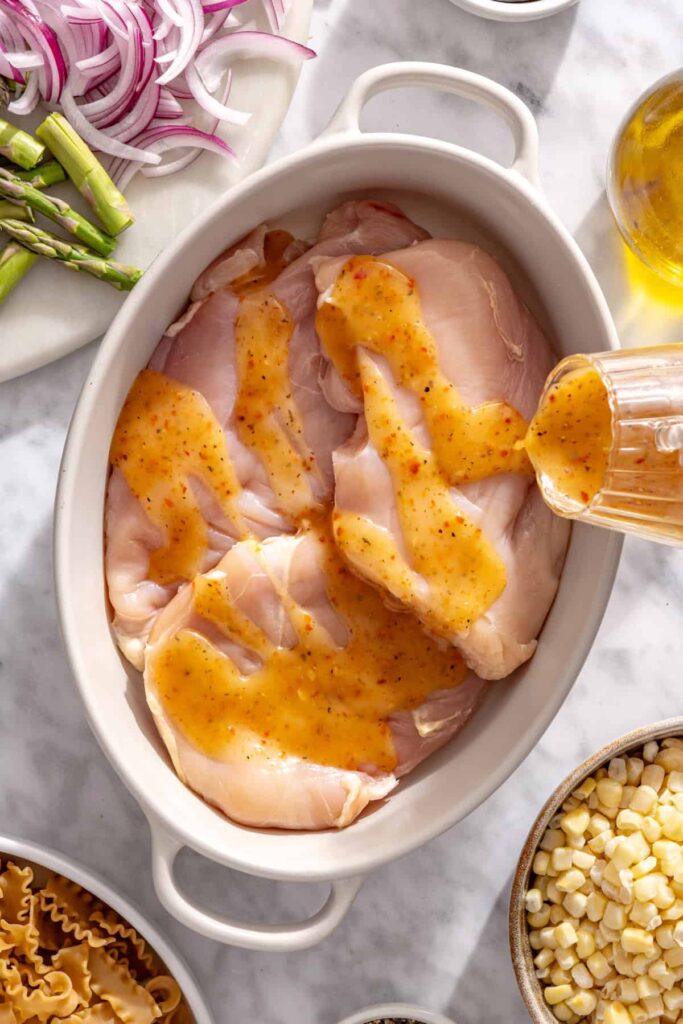 Chicken coated in Italian vinaigrette and lime juice before grilling