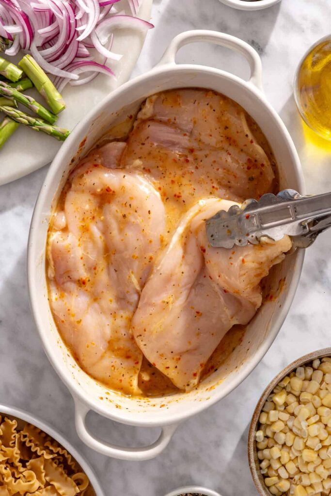 Chicken breasts marinating in Italian vinaigrette and fresh lime juice