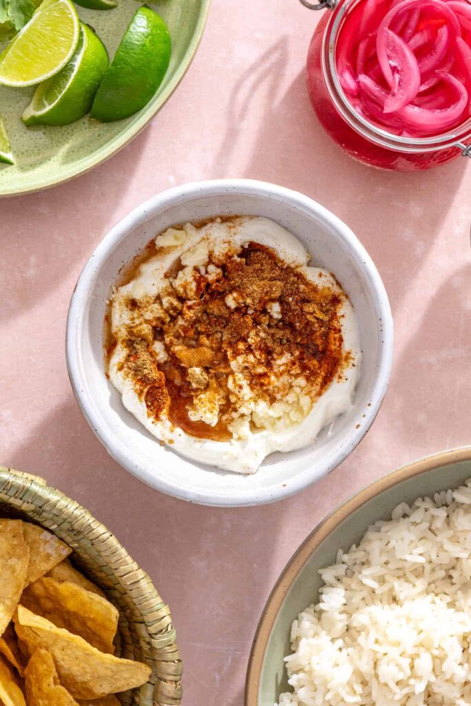 Greek yogurt, cotija cheese, lime juice, and spices for street corn sauce