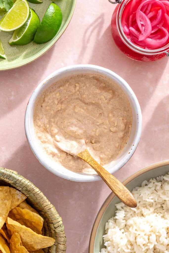 Smooth creamy lime cotija sauce ready to drizzle over the taco skillet