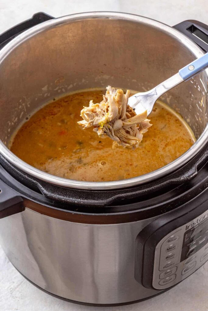 Shredded chicken added back to the Instant Pot buffalo chicken chili