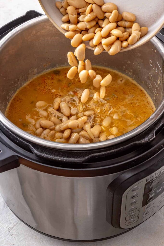 Whole cannellini beans added to buffalo chicken chili in the Instant Pot