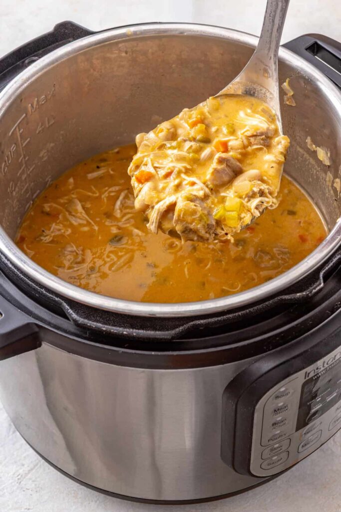 Close-up Instant Pot buffalo chicken chili with a ladleful of creamy chili