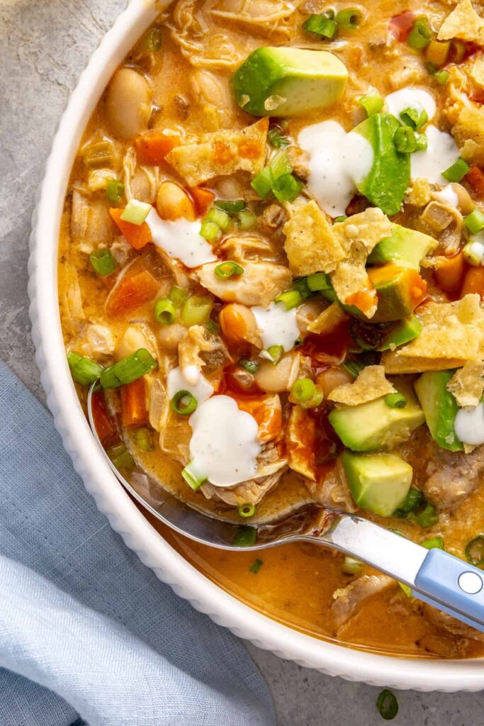 Close-up overhead buffalo chicken chili with shredded chicken, cannellini beans and vegetables