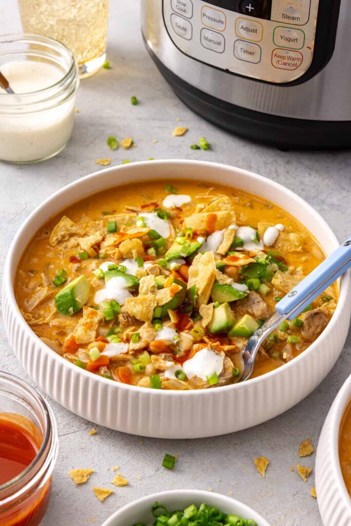 Side angle bowl of buffalo chicken chili with the Instant Pot in the background