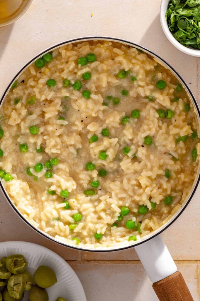 Creamy parmesan rice with peas, lemon zest and parmesan