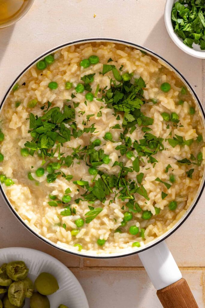 Parmesan, lemon zest, lemon juice, and fresh chopped parsley added to creamy arborio rice