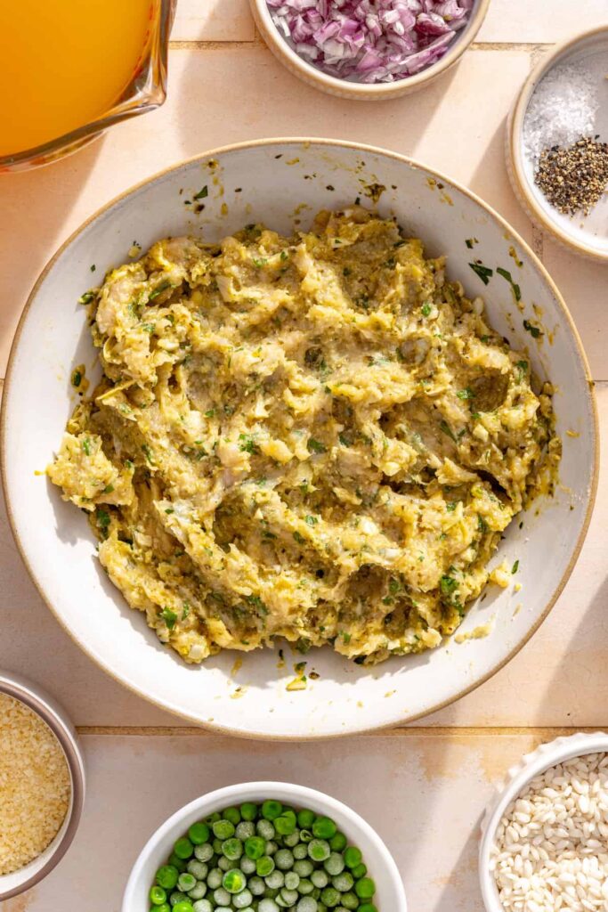 Lemon artichoke chicken meatball mixture prepared in a mixing bowl