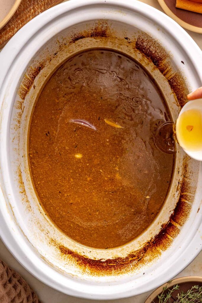 Apple cider vinegar stirred into thickened apple cider gravy to balance the flavor.