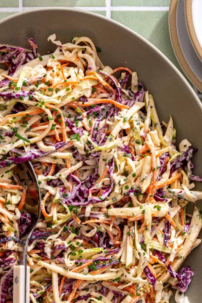 Creamy ranch cabbage slaw with finely shredded green and red cabbage and crisp apple matchsticks.