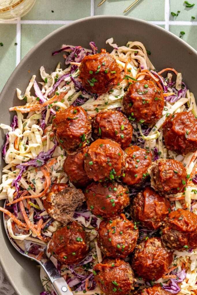 sticky BBQ meatballs over homemade ranch slaw, ready to serve