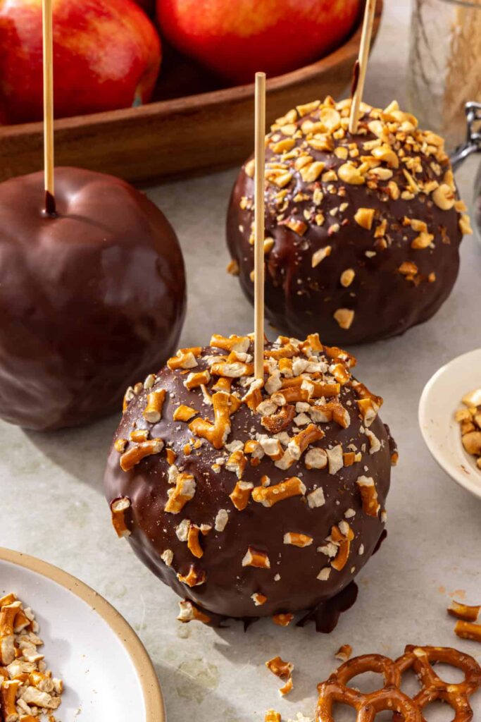 Chocolate date caramel apples with plain, nut-coated and pretzel-coated variations
