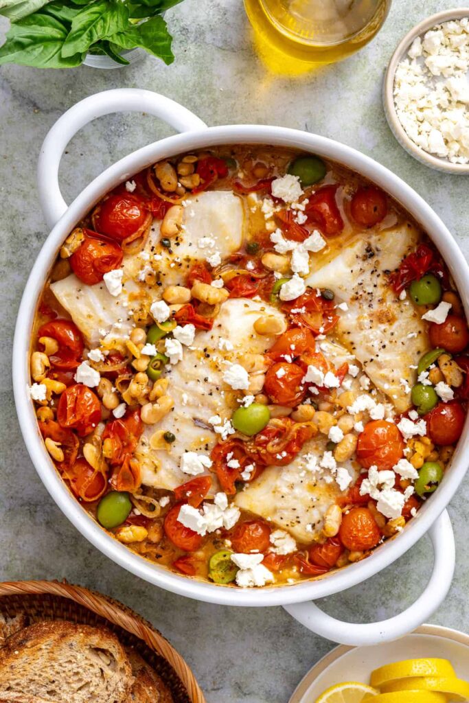 Crumbled feta added to Mediterranean baked cod with roasted cherry tomatoes and cannellini beans.