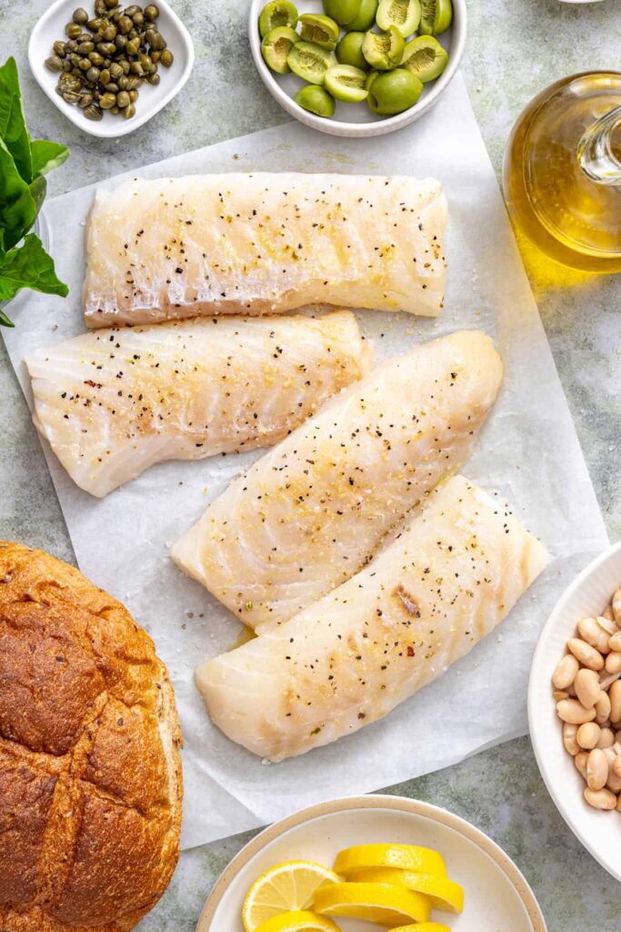 Cod fillets patted dry then drizzled with olive oil and seasoned with garlic powder, sea salt, and black pepper.