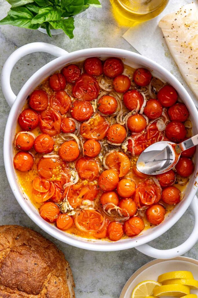 Roasted cherry tomatoes gently smashed with a spoon to release their juices and create a jammy sauce.
