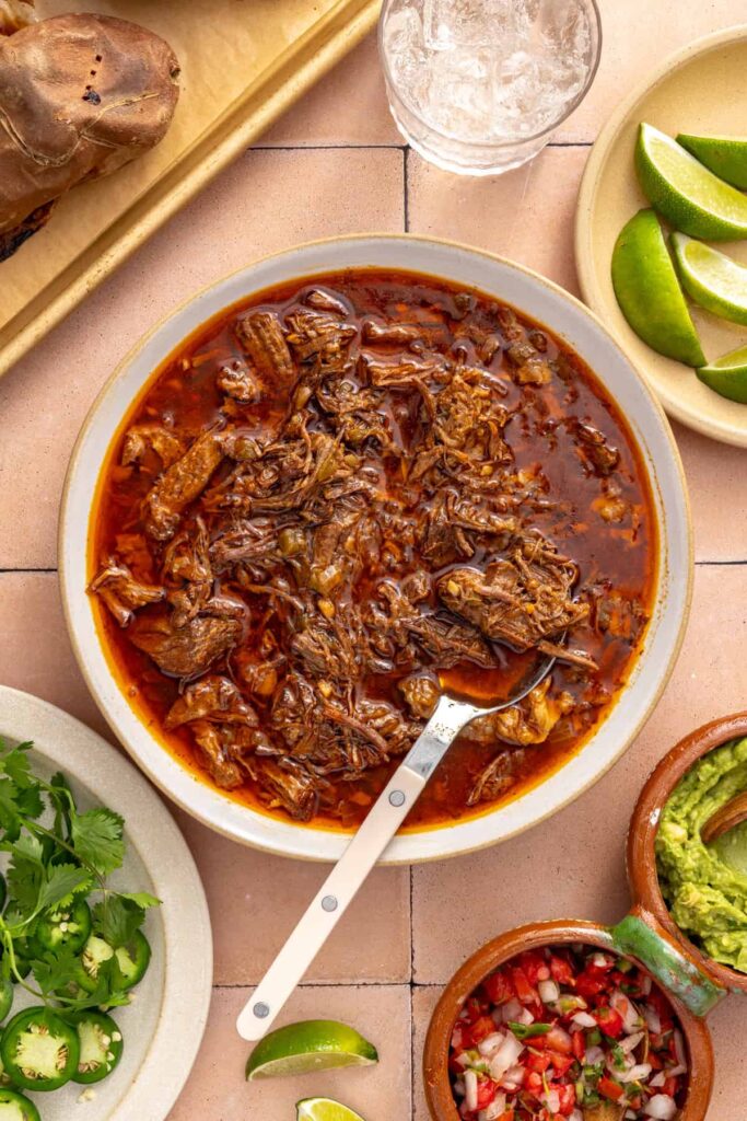 Tender Instant Pot beef chuck roast shredded with two forks for beef taco sweet potatoes.