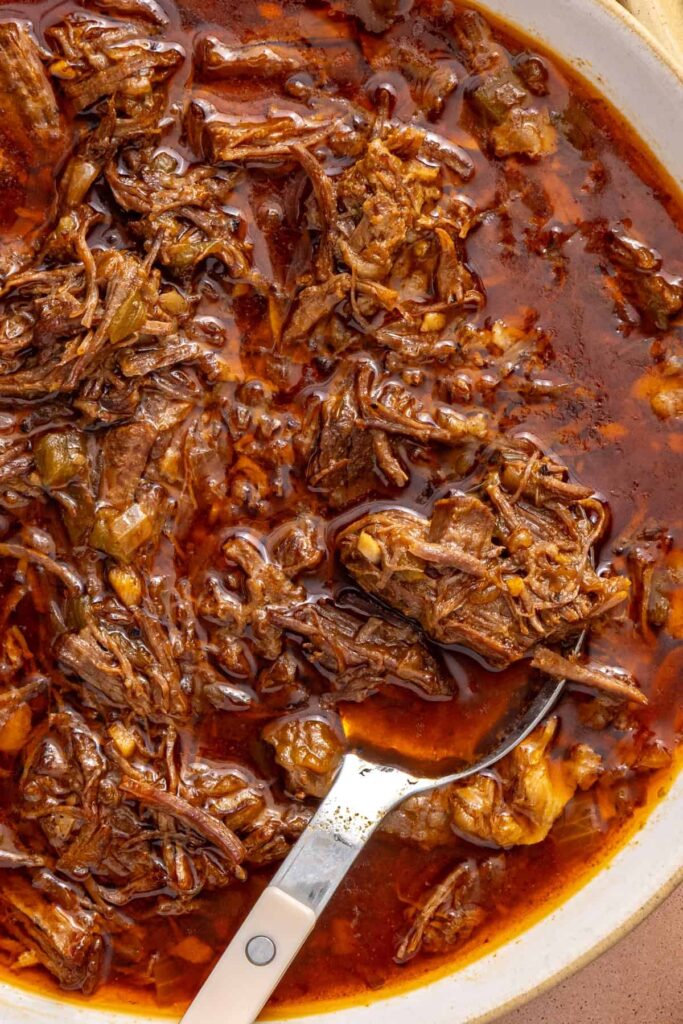 close-up overhead shot of juicy, tender, shredded beef chuck roast made in the Instant Pot