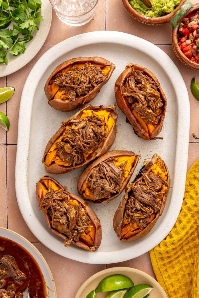 Overhead view of beef taco stuffed sweet potatoes filled with tender shredded Instant Pot beef.