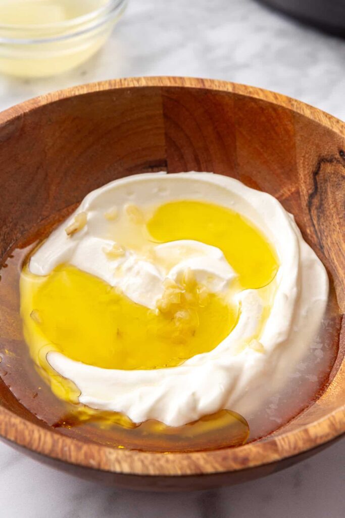 Greek yogurt mixed with fresh lemon juice, olive oil, grated garlic, and salt for a creamy lemon yogurt sauce.