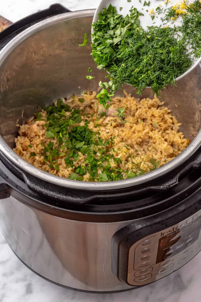 Fresh dill and chopped parsley stirred into fluffy lemon rice in the Instant Pot.